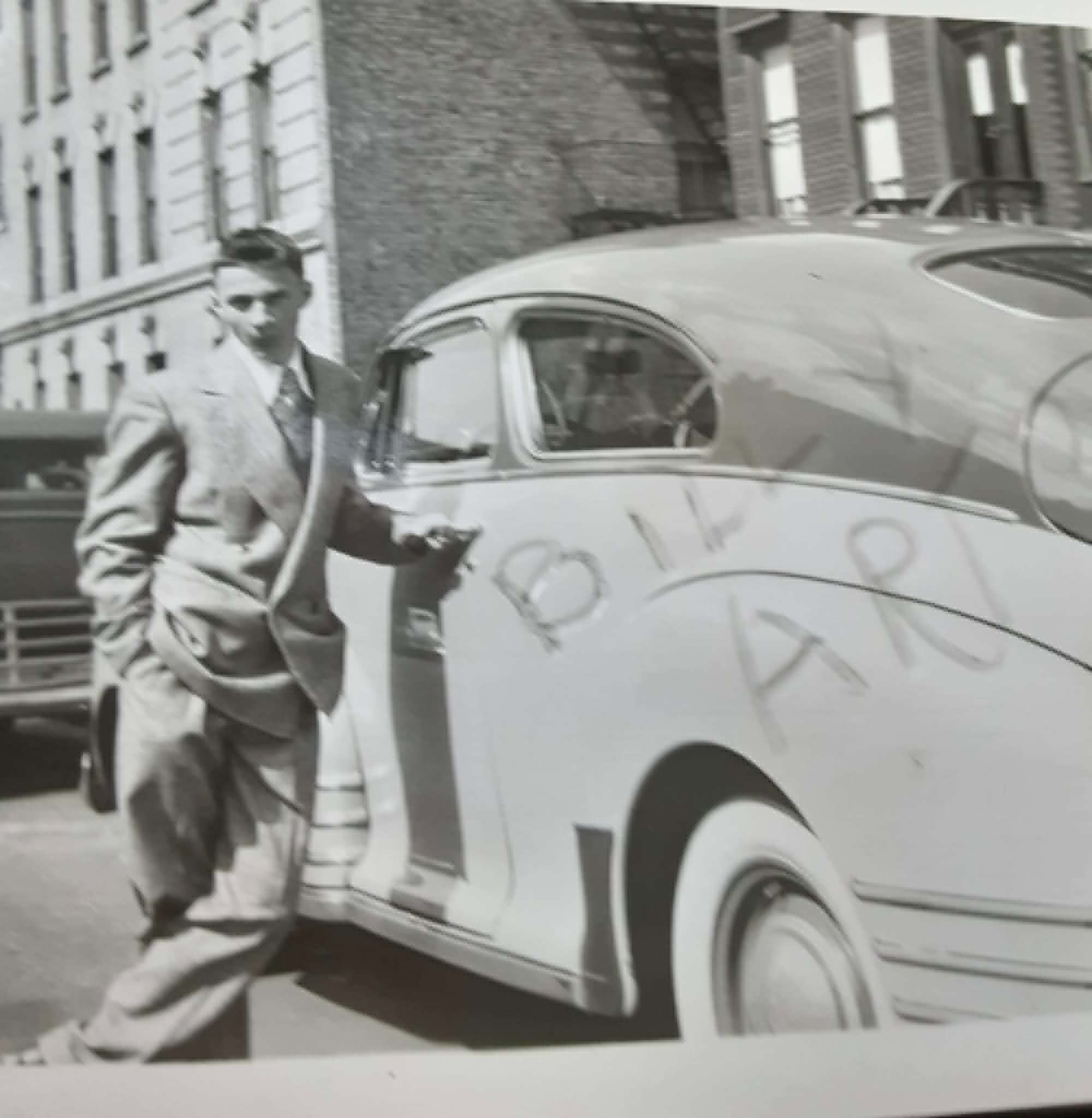 Bill Artz at #35, c. 1948, standing beside a car with "BILL ARZ" written on the trunk. He had moved into the house in 1939 at age 7.